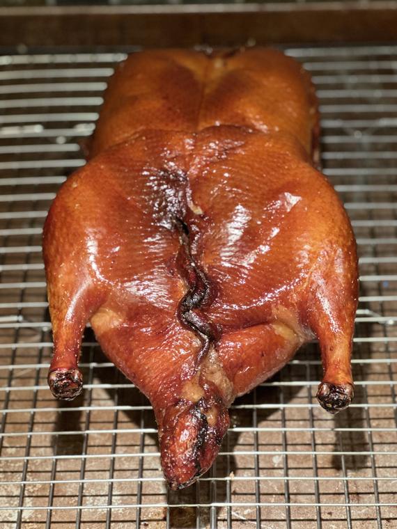 Whole duck, lacquered and air-dried, resting on a rack