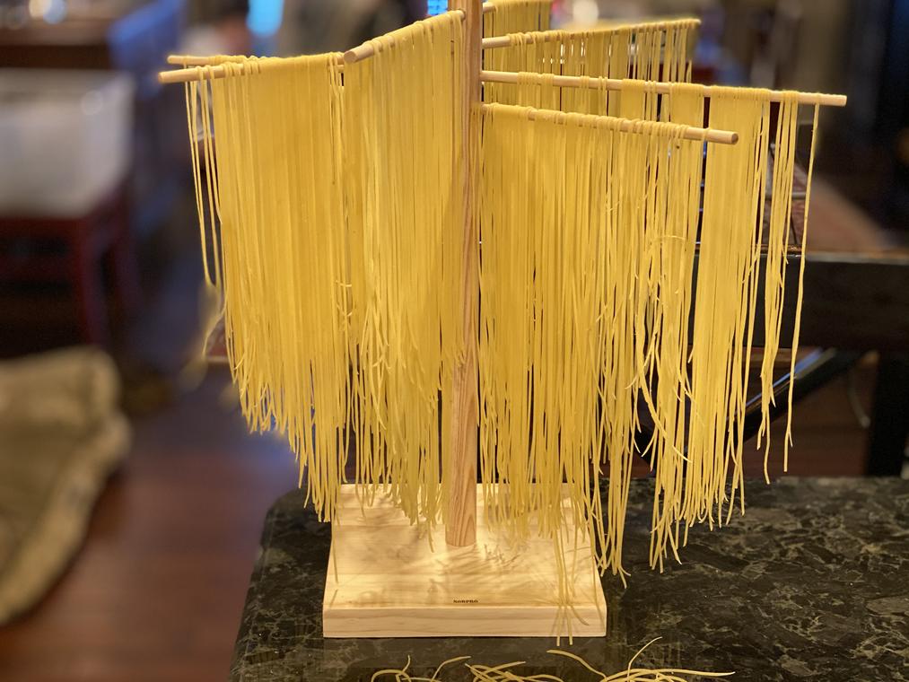 Fresh pasta hung to dry on a rack