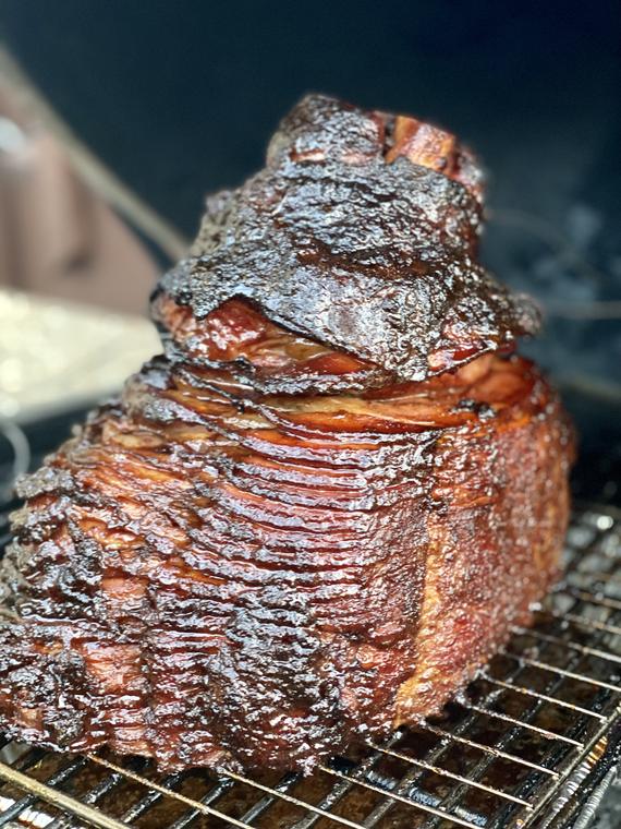 Glazed spiral ham on the smoker rack