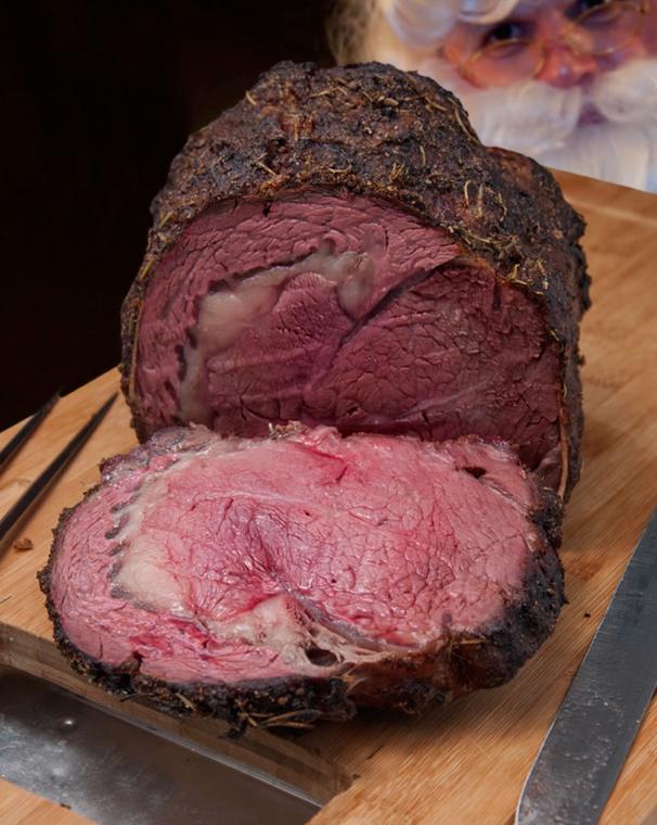 Prime rib with a dark crust, cut to show the rare centre